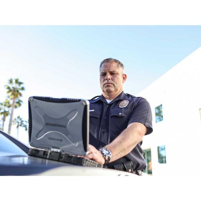 Public safety law enforcement officer using laptop with CentralSquare CAD Pro computer aided dispatch software solutions