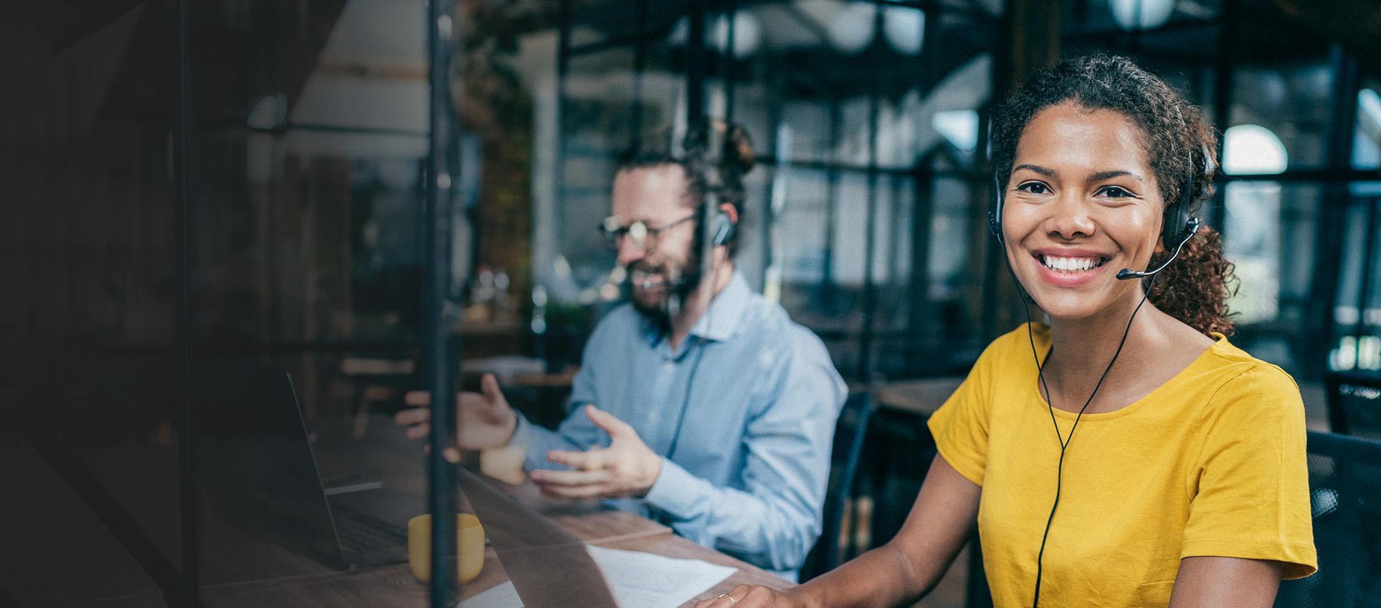 Mobile optimized stock image of a smiling woman wearing a phone headset.