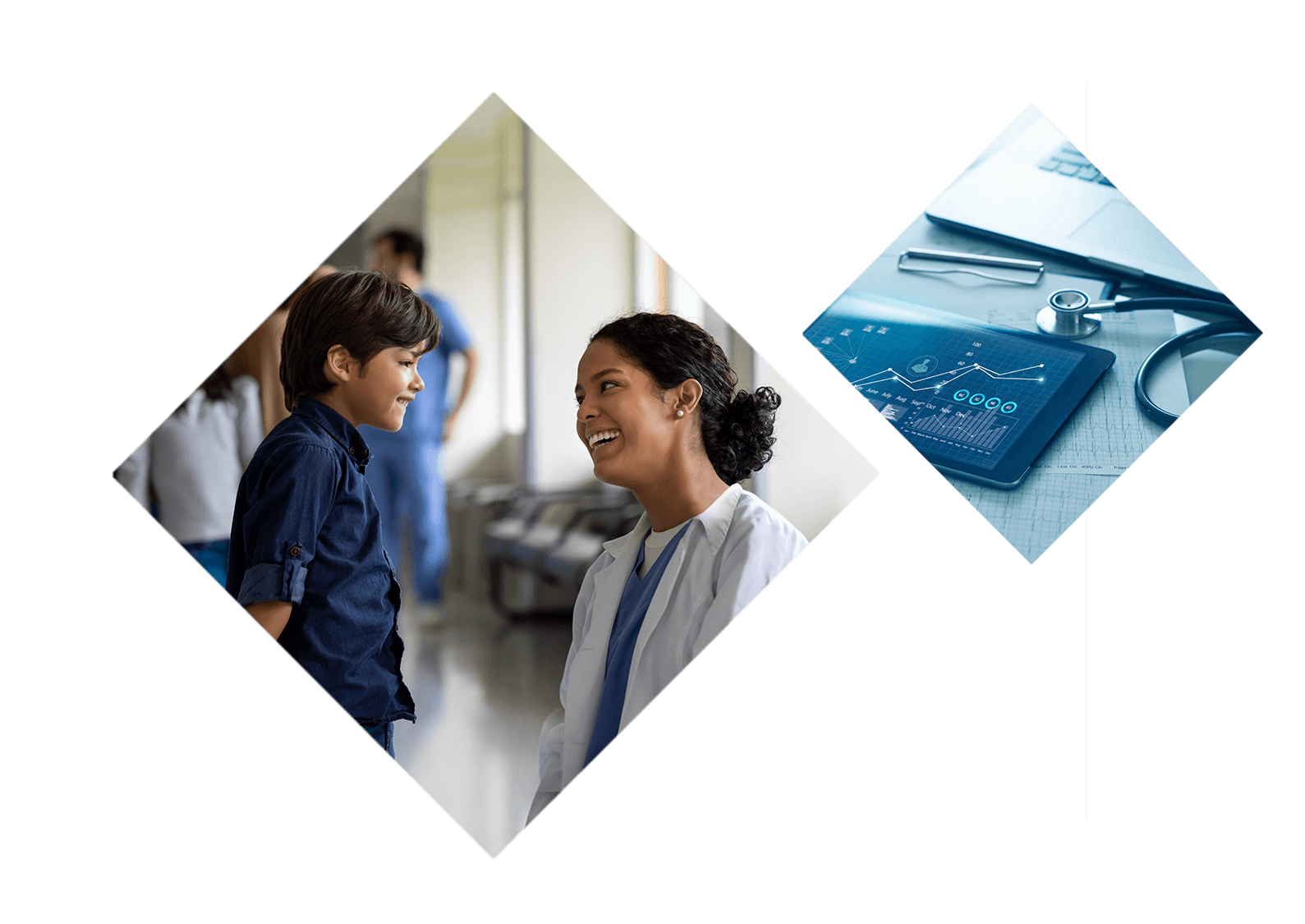 A doctor kneels in the hallway of a clinical setting, smiling and speaking to a young boy.