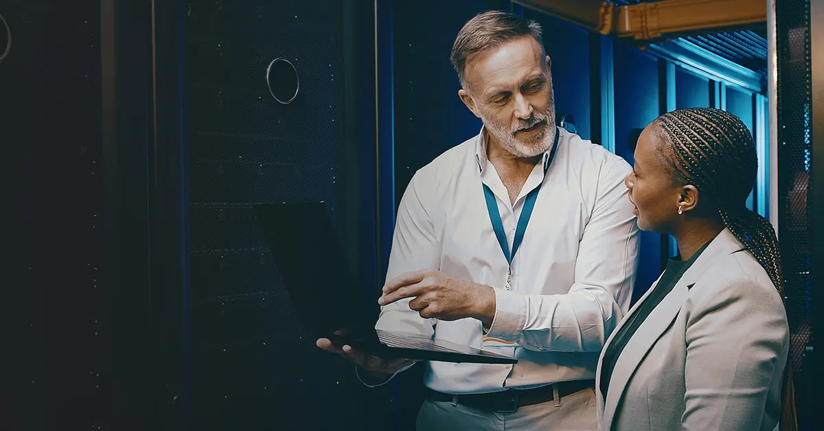 A man and a woman discussing in an IT building