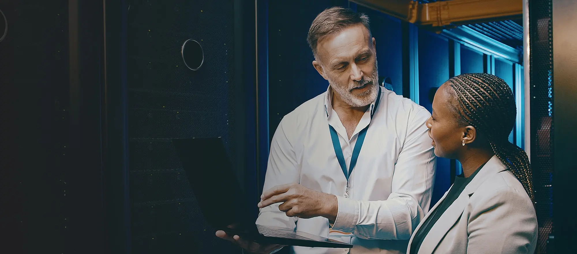 A man and a woman discussing in an IT building