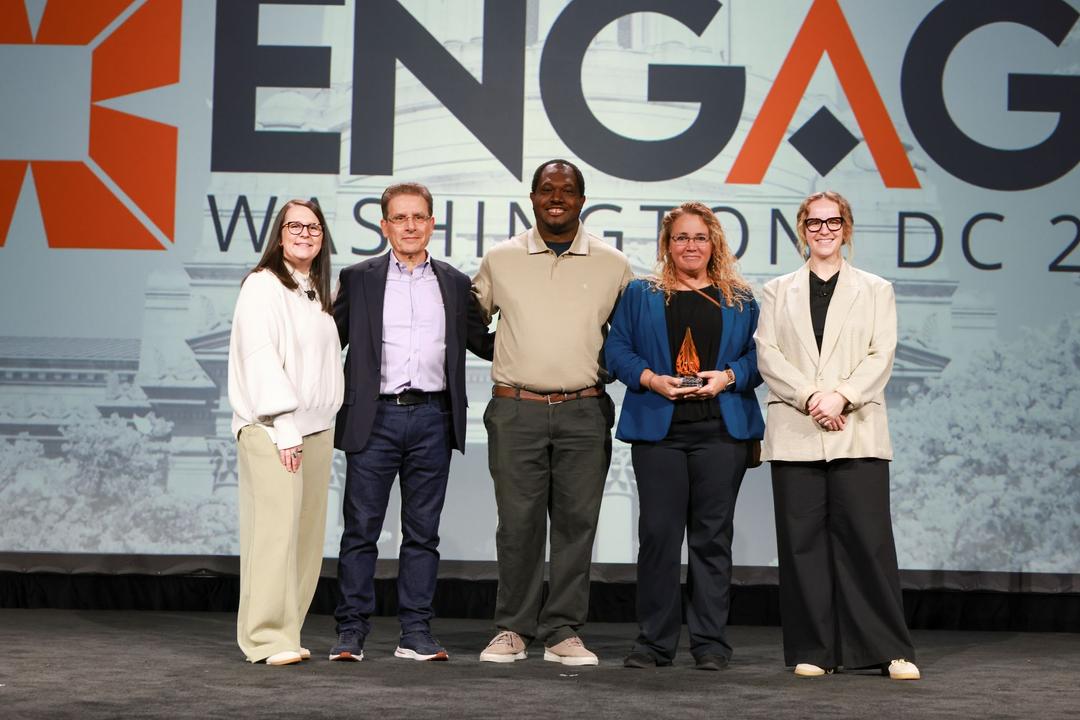 five people standing on stage