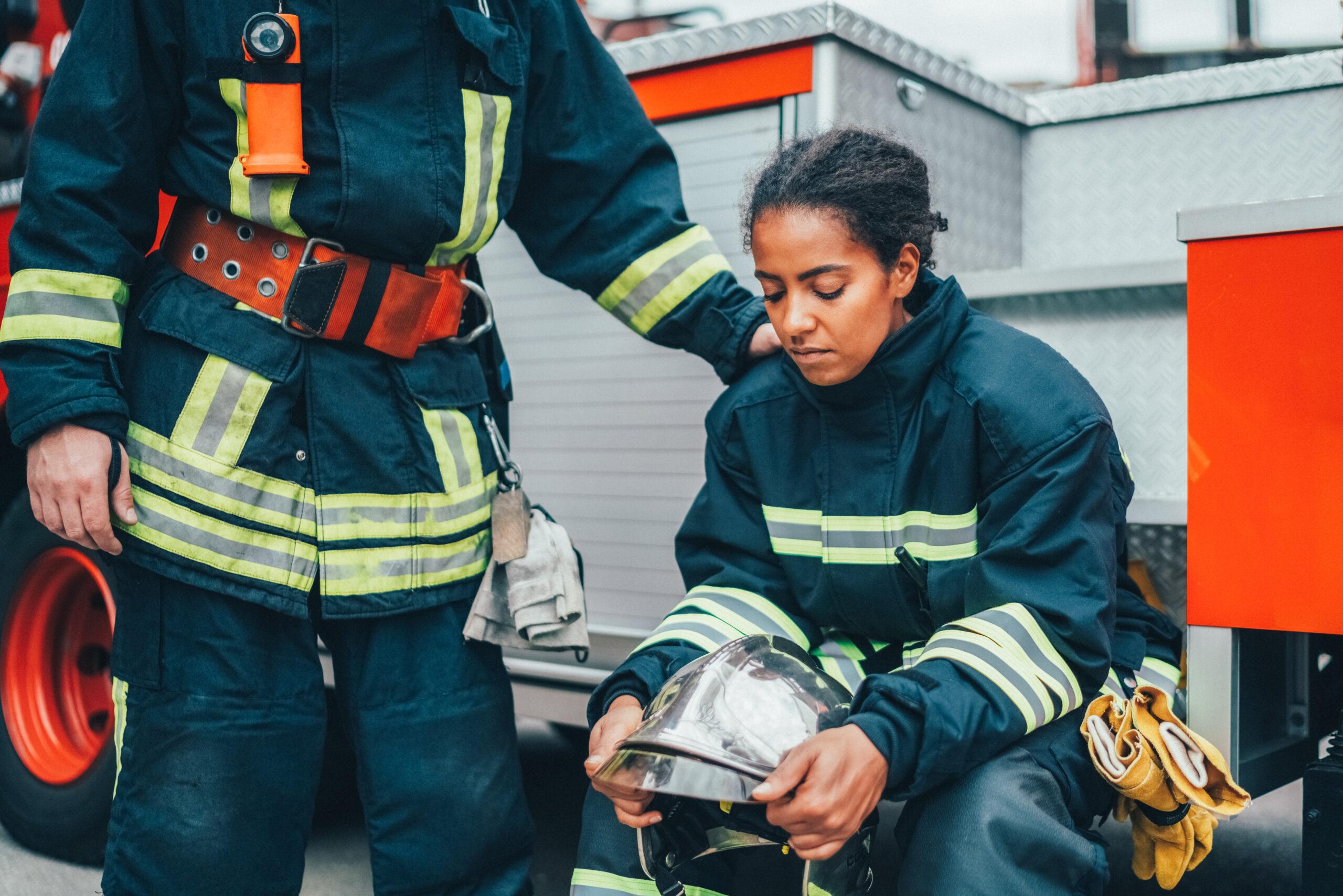 Young firefighter sitting at the firefighter truck after failure on rescue operation