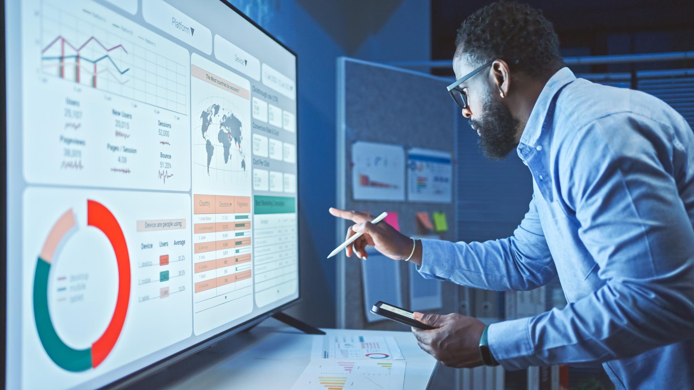 A Man Reviews the Data on a screen.